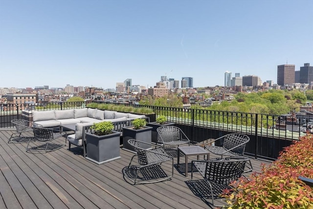 wooden deck featuring an outdoor hangout area and a view of skyline