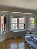 bedroom with dark wood finished floors and baseboards