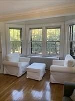 living room featuring crown molding, plenty of natural light, and wood finished floors