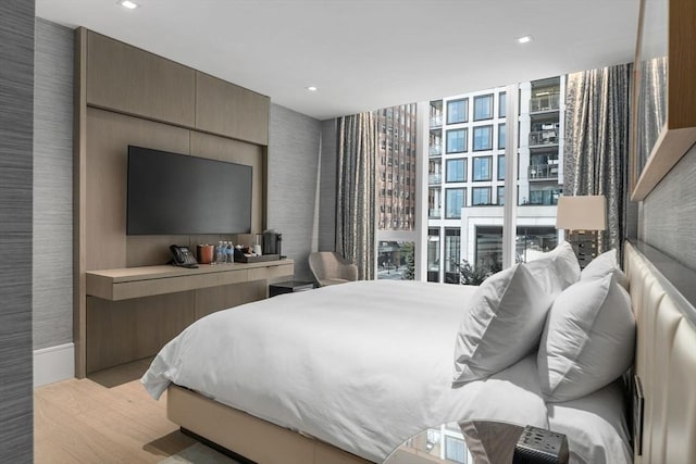 150 Seaport Blvd Unit 11C, Boston, MA 02210 - bedroom featuring wood finished floors, wallpapered walls, recessed lighting, and multiple windows