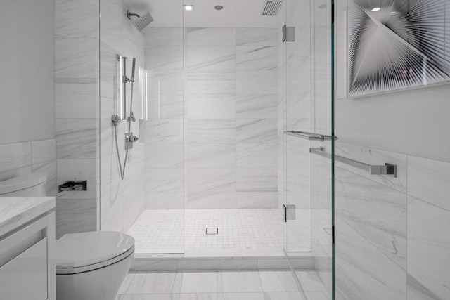 150 Seaport Blvd Unit 11C, Boston, MA 02210 - bathroom featuring toilet, vanity, a stall shower, and tile walls