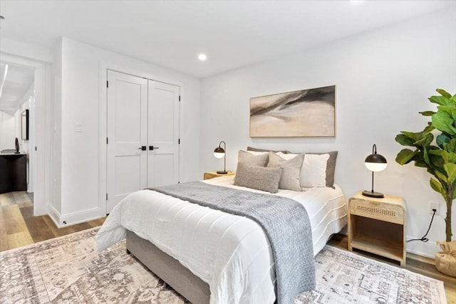 157 Princeton St Unit 1, Boston, MA 02128 - bedroom with wood finished floors, recessed lighting, a closet, and baseboards