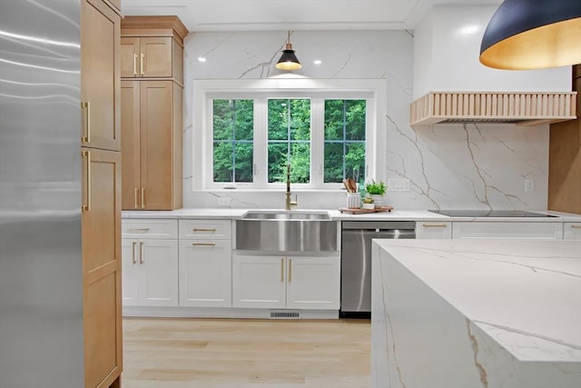 293 Cross St, Norwell, MA 02061 - kitchen featuring appliances with stainless steel finishes, light wood finished floors, light stone counters, decorative backsplash, and pendant lighting