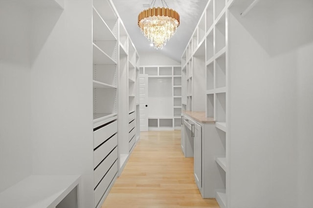 293 Cross St, Norwell, MA 02061 - spacious closet with a chandelier, light wood finished floors, and lofted ceiling