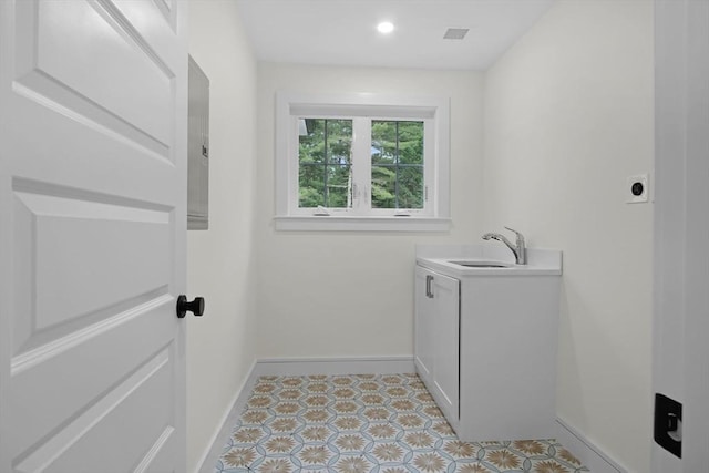 293 Cross St, Norwell, MA 02061 - laundry area featuring cabinet space, electric dryer hookup, and light tile patterned floors
