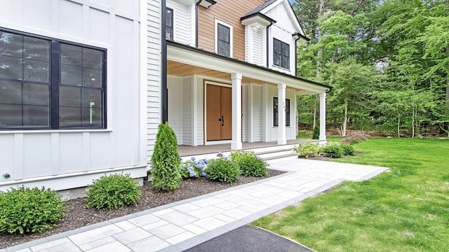 293 Cross St, Norwell, MA 02061 - doorway to property featuring board and batten siding, a porch, and a yard