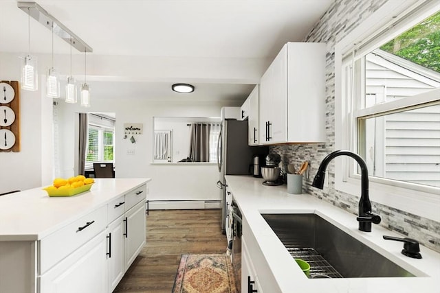 186 Andover St, North Andover, MA 01845 - kitchen featuring dishwasher, a baseboard heating unit, decorative backsplash, light countertops, and dark wood-style floors