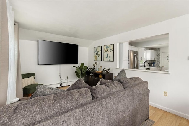 186 Andover St, North Andover, MA 01845 - living room featuring light wood finished floors and a baseboard heating unit