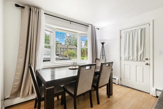 186 Andover St, North Andover, MA 01845 - dining room featuring light wood-style floors and a baseboard heating unit