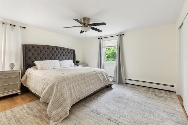 186 Andover St, North Andover, MA 01845 - bedroom featuring a baseboard heating unit, wood finished floors, and ceiling fan