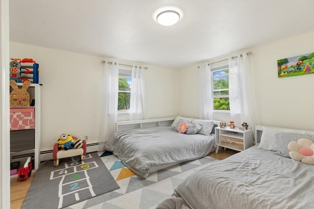 186 Andover St, North Andover, MA 01845 - bedroom with multiple windows, wood finished floors, and baseboard heating