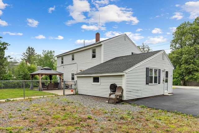 186 Andover St, North Andover, MA 01845 - back of property featuring a gazebo, a chimney, and a shingled roof