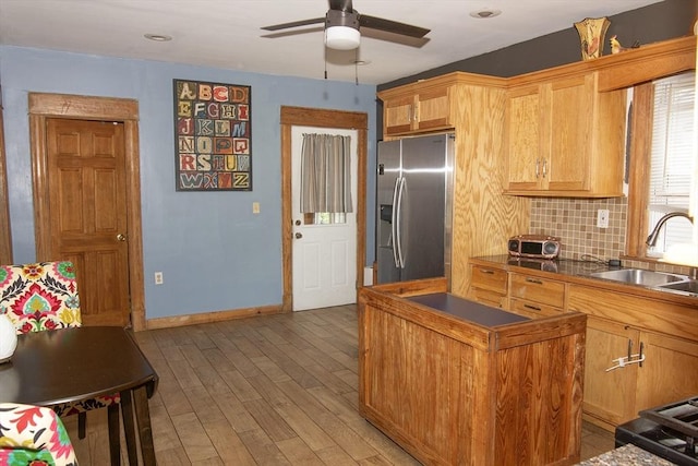 103 Monrovia St, Springfield, MA 01104 - kitchen featuring stainless steel fridge with ice dispenser, a ceiling fan, light wood finished floors, decorative backsplash, and dark countertops