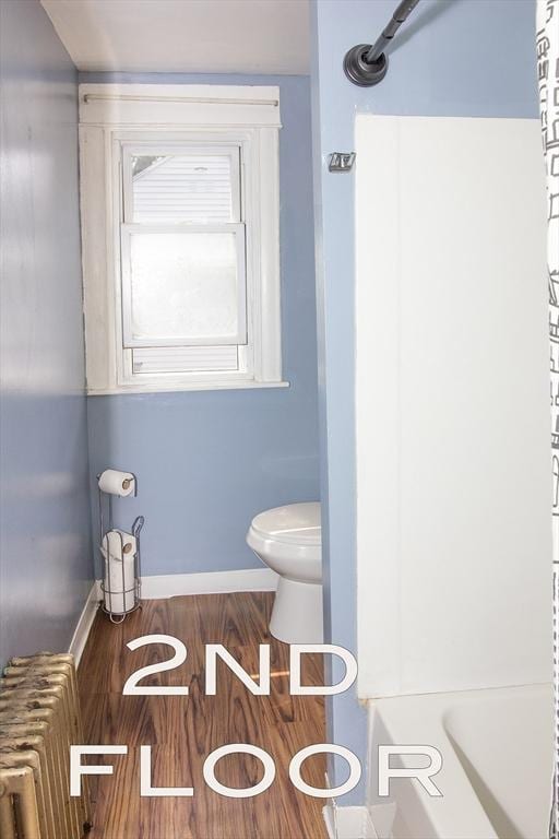 103 Monrovia St, Springfield, MA 01104 - bathroom with radiator heating unit, a shower, and wood finished floors