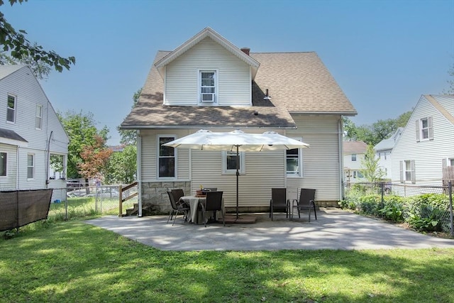 103 Monrovia St, Springfield, MA 01104 - back of property with a fenced backyard, a patio area, and roof with shingles