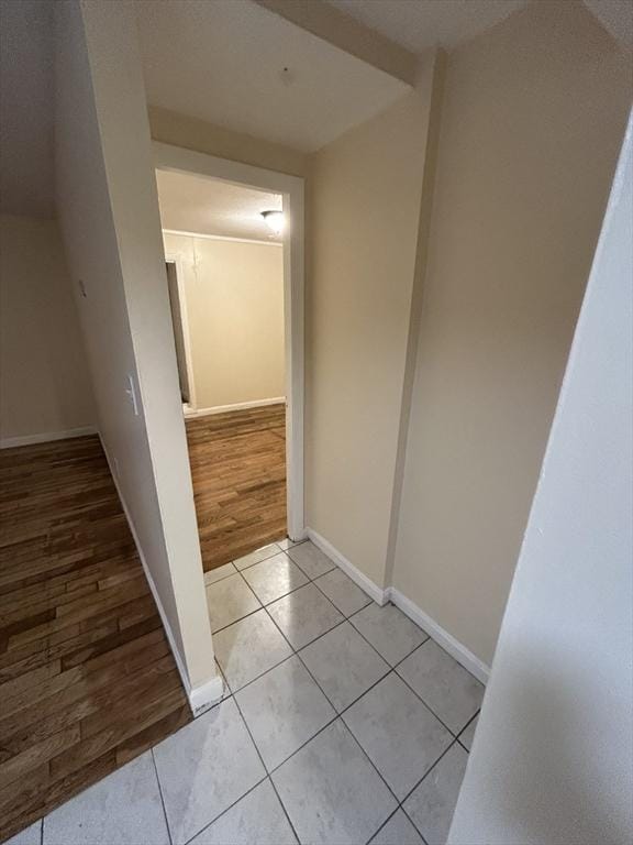 corridor featuring light tile patterned floors