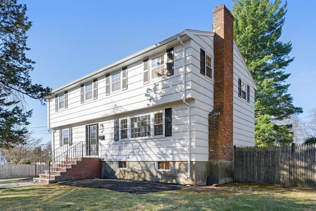 110 Westover Pkwy, Norwood, MA 02062 - colonial home featuring a chimney, fence, and a front yard