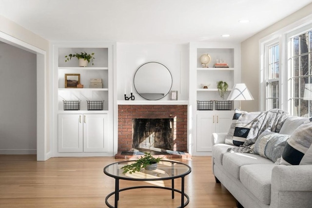 110 Westover Pkwy, Norwood, MA 02062 - living room with a fireplace, baseboards, built in features, and light wood-style flooring