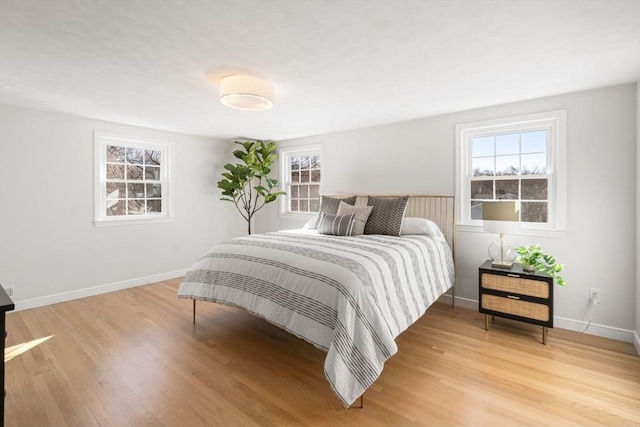 110 Westover Pkwy, Norwood, MA 02062 - bedroom featuring baseboards, multiple windows, and light wood-style flooring