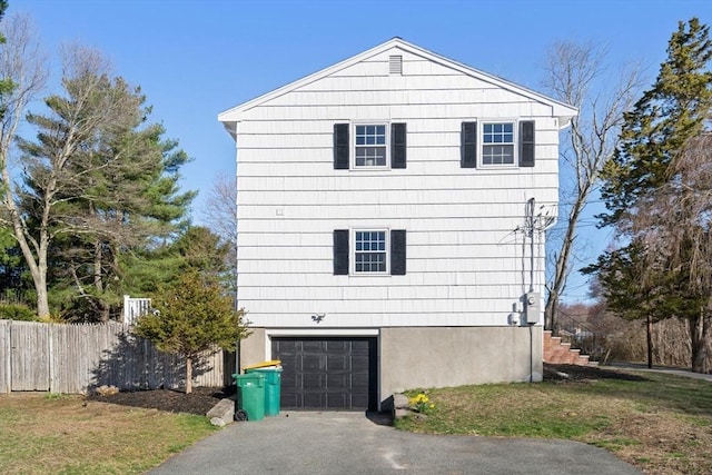 110 Westover Pkwy, Norwood, MA 02062 - view of side of home featuring an attached garage, driveway, and fence