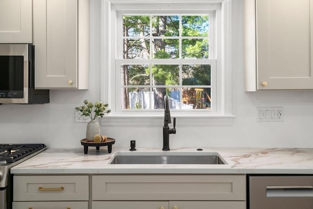 110 Westover Pkwy, Norwood, MA 02062 - kitchen with light stone counters, a sink, and appliances with stainless steel finishes