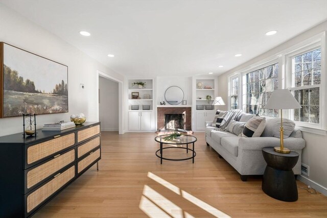 110 Westover Pkwy, Norwood, MA 02062 - living area with light wood-type flooring, visible vents, and built in shelves