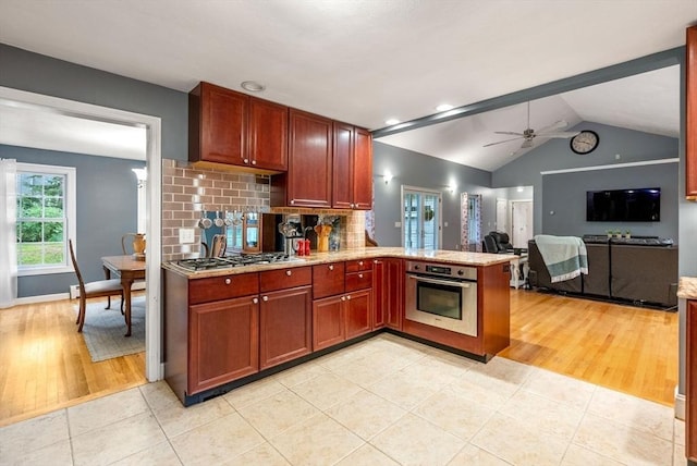 495 Grafton St, Shrewsbury, MA 01545 - kitchen with tasteful backsplash, a peninsula, light tile patterned floors, a ceiling fan, and stainless steel appliances