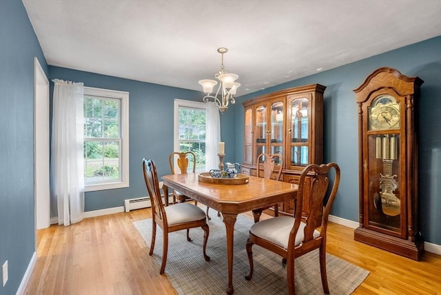 495 Grafton St, Shrewsbury, MA 01545 - dining room with light wood-style flooring, an inviting chandelier, baseboards, and a baseboard heating unit