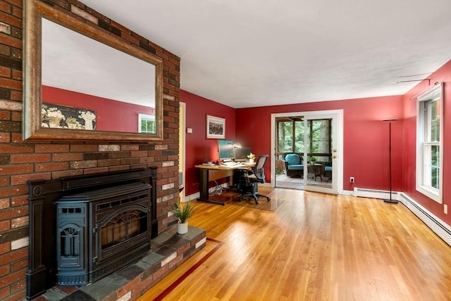495 Grafton St, Shrewsbury, MA 01545 - office area with plenty of natural light, baseboards, a wood stove, and wood finished floors