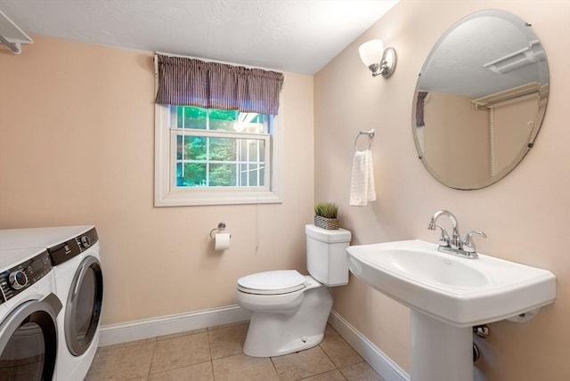 495 Grafton St, Shrewsbury, MA 01545 - bathroom with baseboards, tile patterned floors, toilet, independent washer and dryer, and a sink