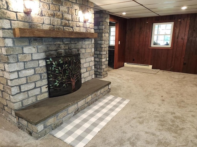 495 Grafton St, Shrewsbury, MA 01545 - unfurnished living room with a drop ceiling, a fireplace, carpet flooring, wood walls, and a baseboard radiator