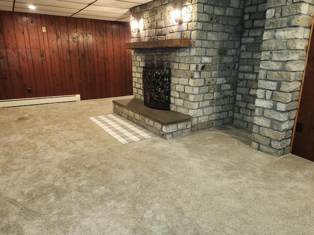 495 Grafton St, Shrewsbury, MA 01545 - finished below grade area featuring wood walls, a fireplace, carpet flooring, and baseboard heating