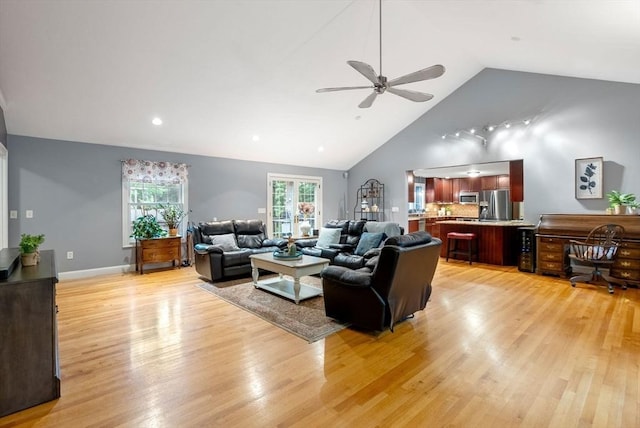 495 Grafton St, Shrewsbury, MA 01545 - living room featuring light wood-style flooring, a ceiling fan, high vaulted ceiling, and baseboards