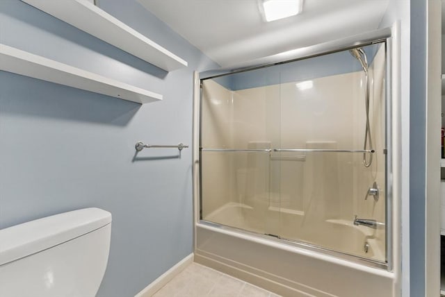 bathroom with toilet, shower / bath combination with glass door, baseboards, and tile patterned flooring
