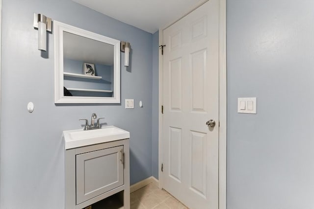 bathroom featuring vanity, baseboards, and tile patterned flooring