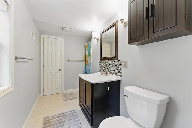 bathroom with tasteful backsplash, vanity, visible vents, toilet, and baseboards