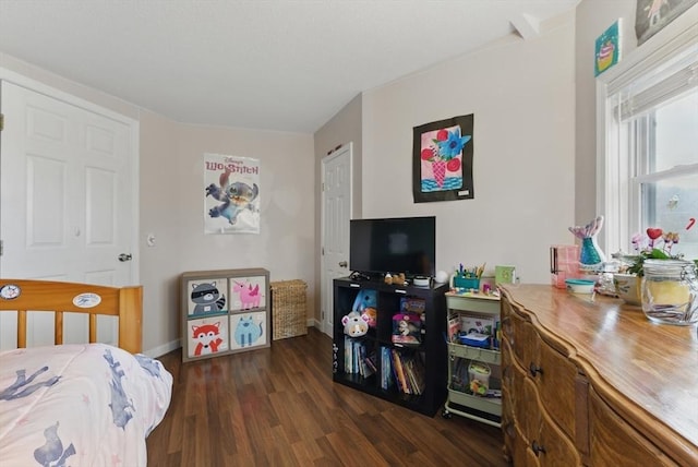 bedroom with baseboards and wood finished floors