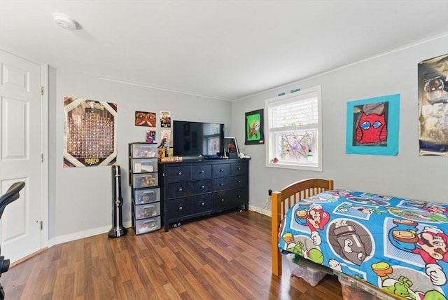 bedroom featuring wood finished floors and baseboards
