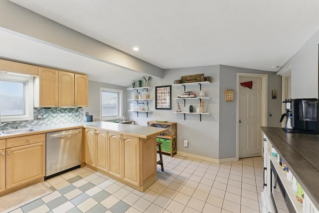 kitchen featuring a sink, vaulted ceiling with beams, dishwasher, and light brown cabinets