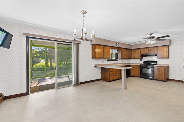 13 Abraham Ave, Freetown, MA 02717 - kitchen with black gas range, wallpapered walls, brown cabinets, under cabinet range hood, and a peninsula