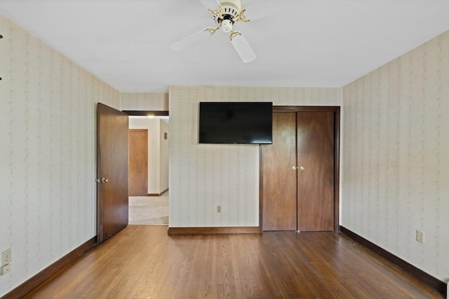 13 Abraham Ave, Freetown, MA 02717 - unfurnished bedroom with wood finished floors, wallpapered walls, ceiling fan, and a closet
