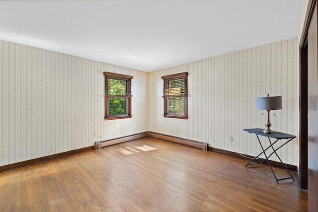 13 Abraham Ave, Freetown, MA 02717 - spare room featuring wood finished floors, wallpapered walls, and a baseboard heating unit
