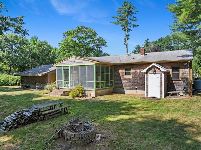 13 Abraham Ave, Freetown, MA 02717 - back of house featuring a fire pit, a sunroom, a chimney, and a lawn