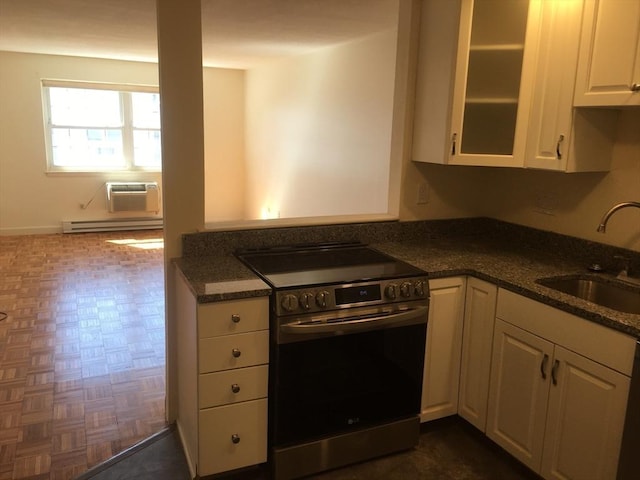881 Main St Unit U10, Walpole, MA 02081 - kitchen with stainless steel electric range oven, a baseboard heating unit, white cabinetry, glass insert cabinets, and an AC wall unit