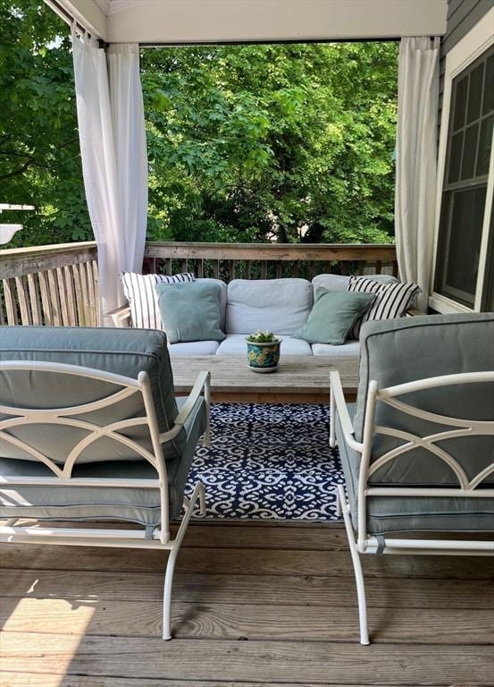 wooden deck with an outdoor living space