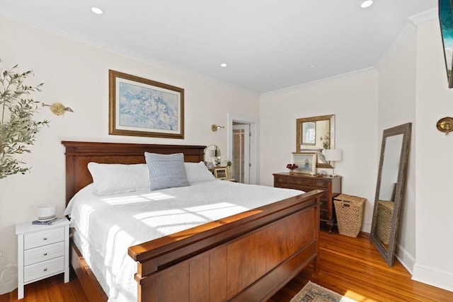 bedroom with crown molding, recessed lighting, and dark wood-style flooring