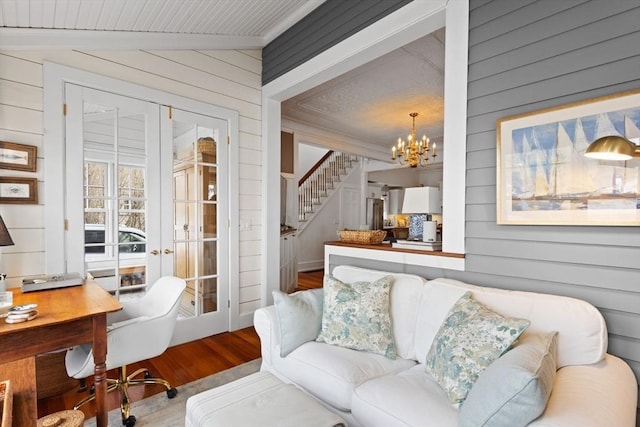 interior space featuring wooden walls, wood finished floors, stairs, vaulted ceiling, and a notable chandelier