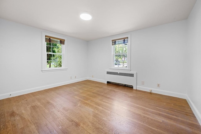 191 Speen, Natick, MA 01760 - spare room featuring radiator heating unit, light wood-type flooring, and plenty of natural light