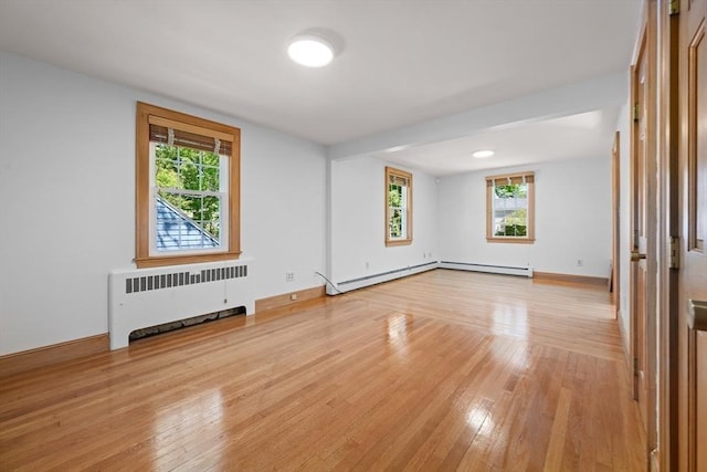191 Speen, Natick, MA 01760 - empty room featuring radiator, light wood finished floors, healthy amount of natural light, and baseboards
