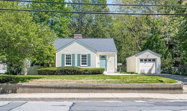 191 Speen, Natick, MA 01760 - view of front of home with an outbuilding, driveway, a chimney, a detached garage, and a front lawn